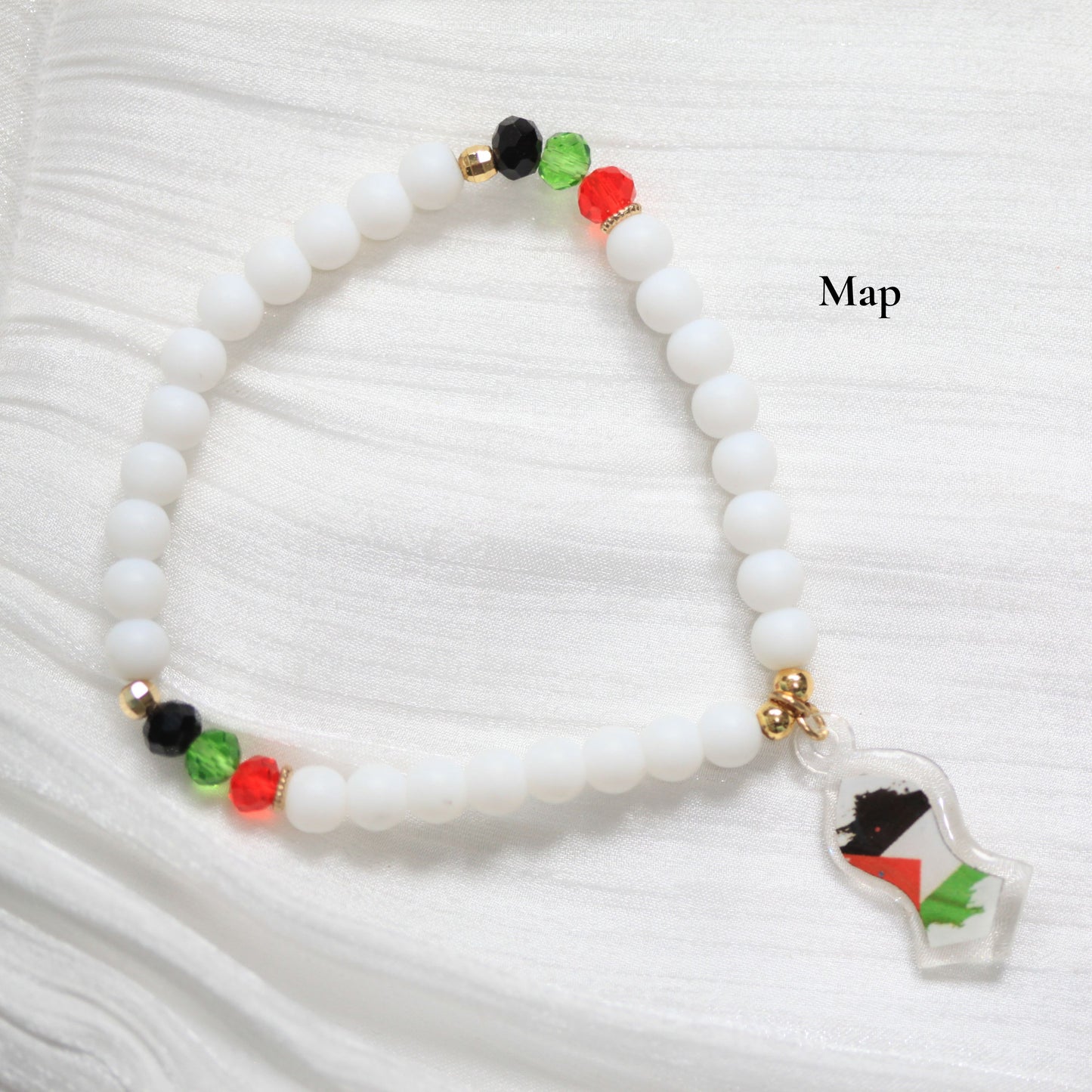 White beaded bracelet with a map charm on a white background