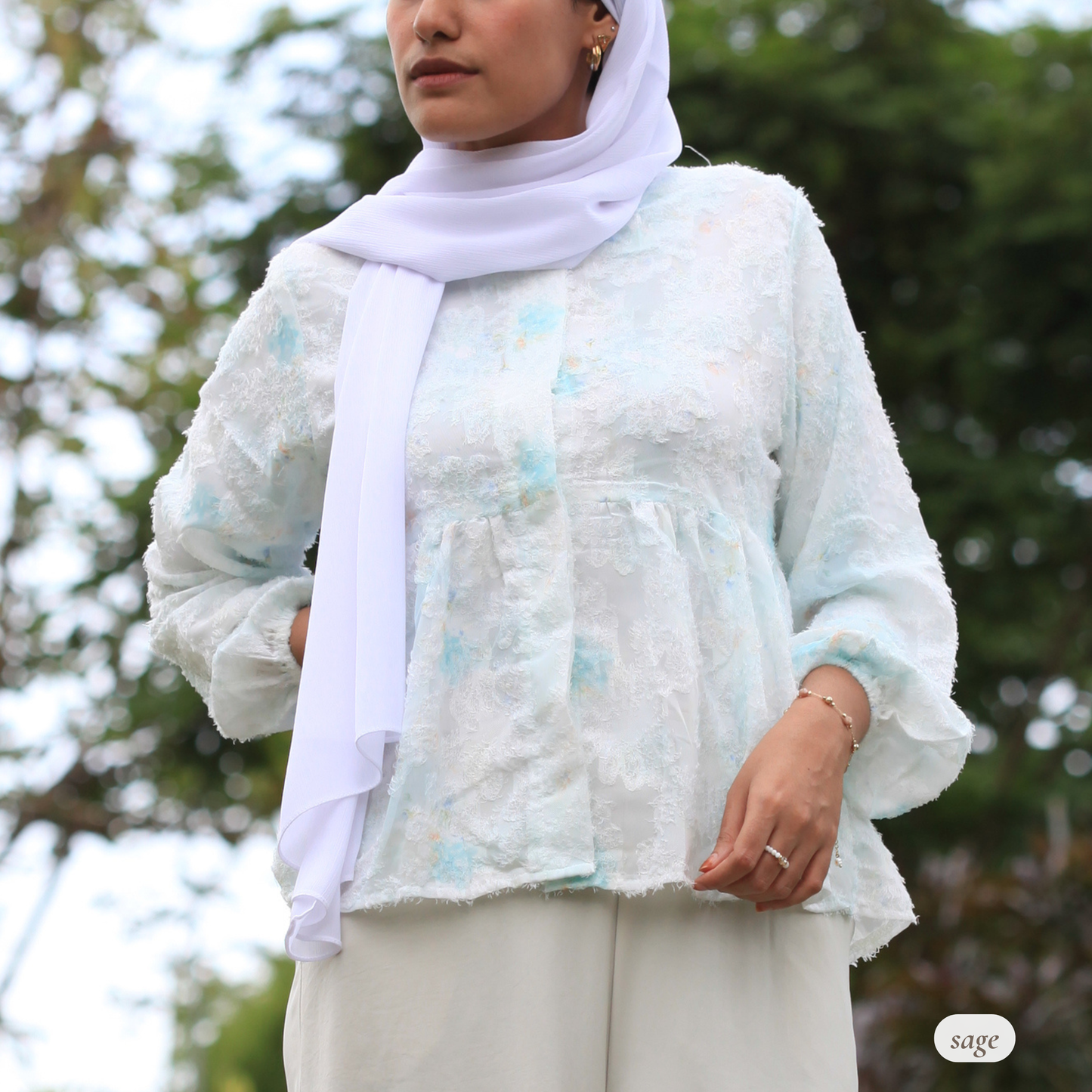 Hijabi model wearing Willow Waltz modest blouse by Dreamers’ Side, featuring ethereal flowy silhouette, soft pastel ombré tones, and elegant modest fashion styling for everyday wear