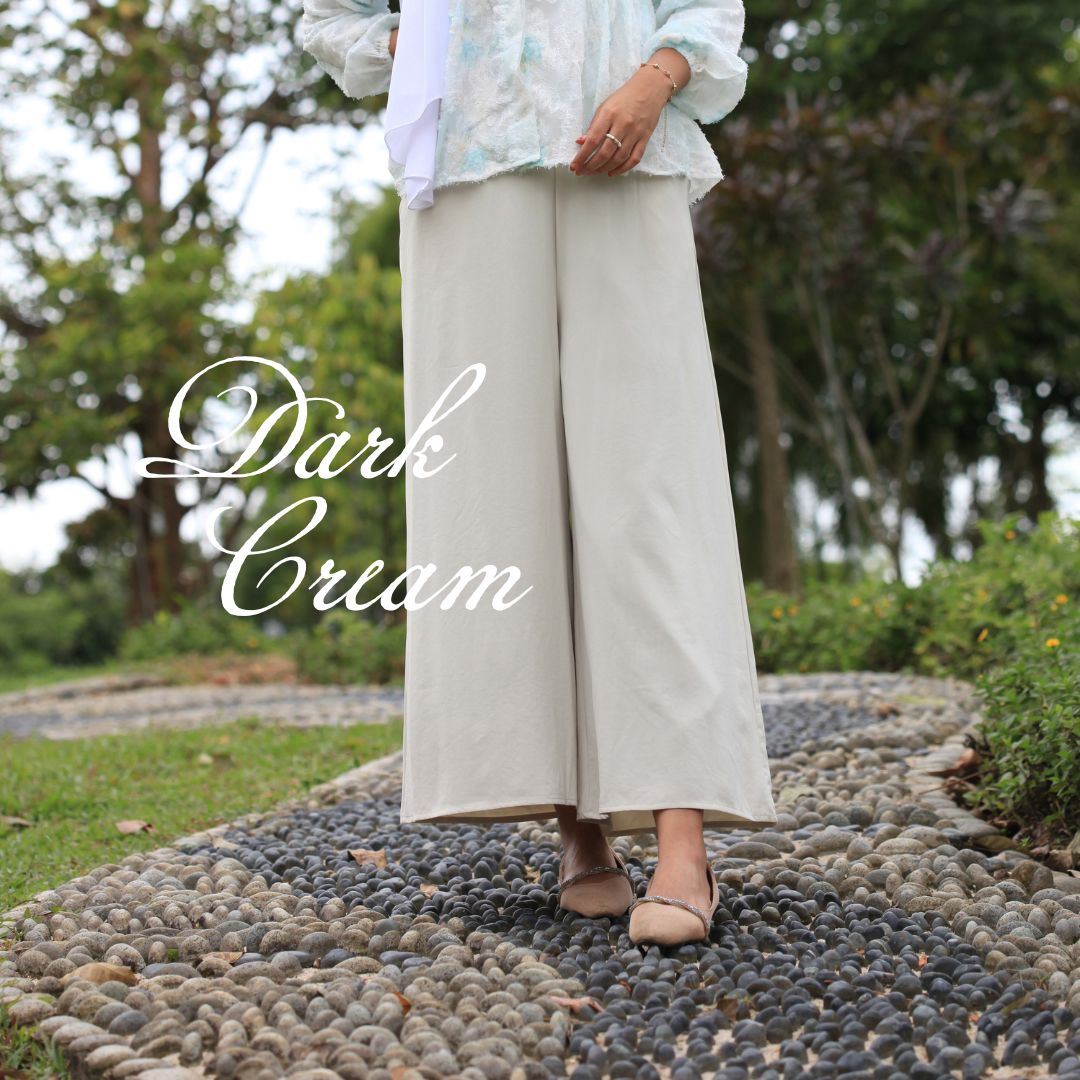 Hijabi model wearing Ariana Palazzo Pants in dark cream colour, featuring a flowy modest wide-leg silhouette with elegant movement