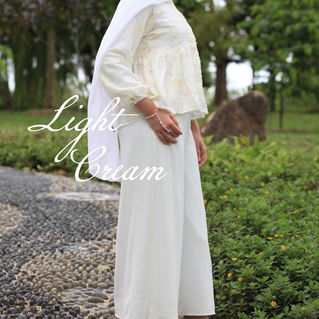 Hijabi model wearing Ariana Palazzo Pants in light cream colour, featuring a flowy modest wide-leg silhouette with elegant movement