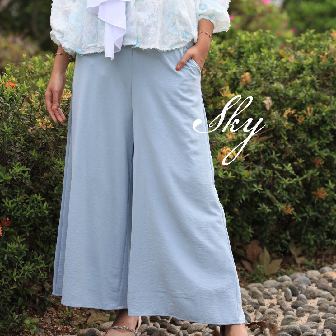 Hijabi model wearing Ariana Palazzo Pants in Sky colour, featuring a flowy modest wide-leg silhouette with elegant movement