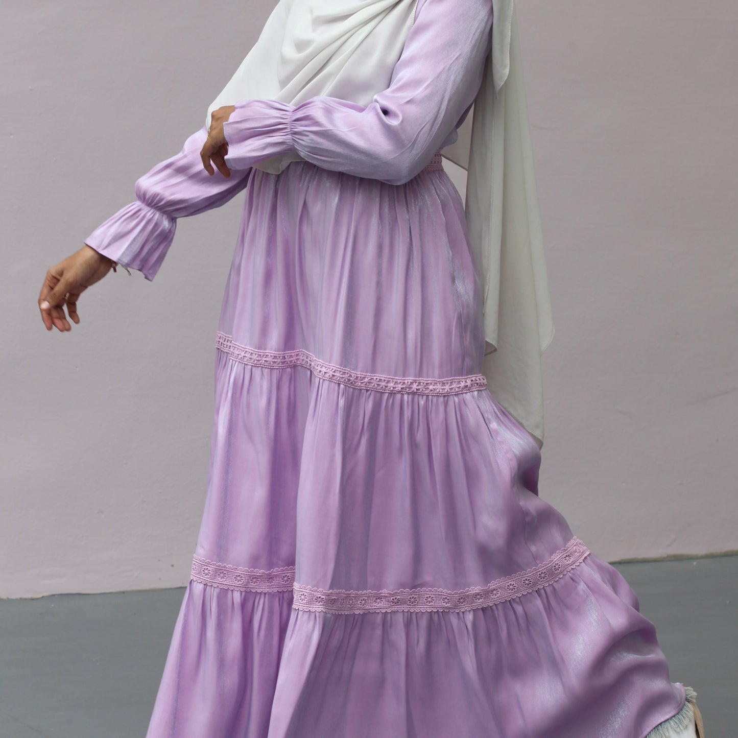 Romantic tiered modest gown with lace accents soft draping fabric elegant feminine formal wear dress