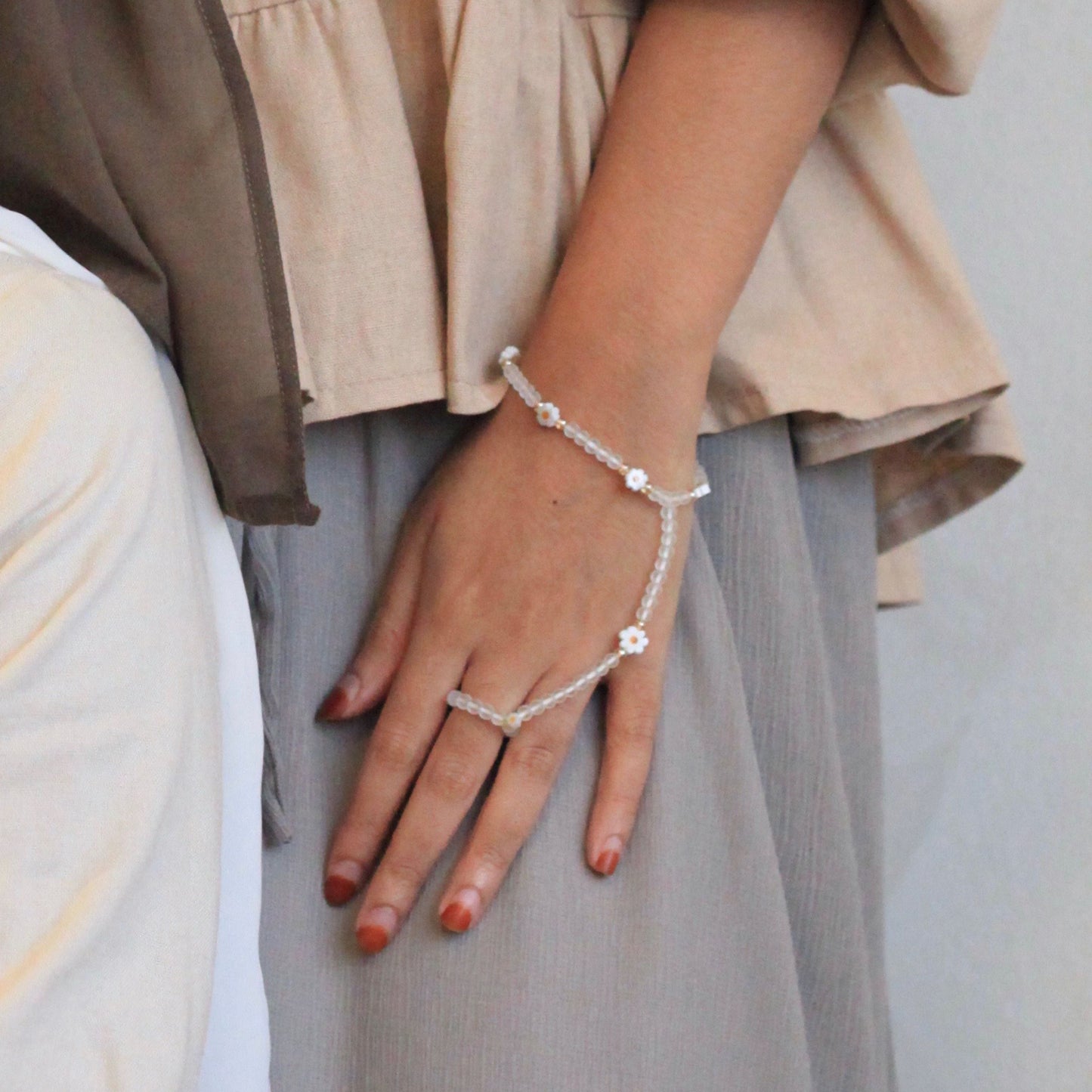 Daisy Dainties handchain by Dreamers’ Side featuring frosted beads and daisy accents, an elegant feminine jewellery piece linking wrist and finger