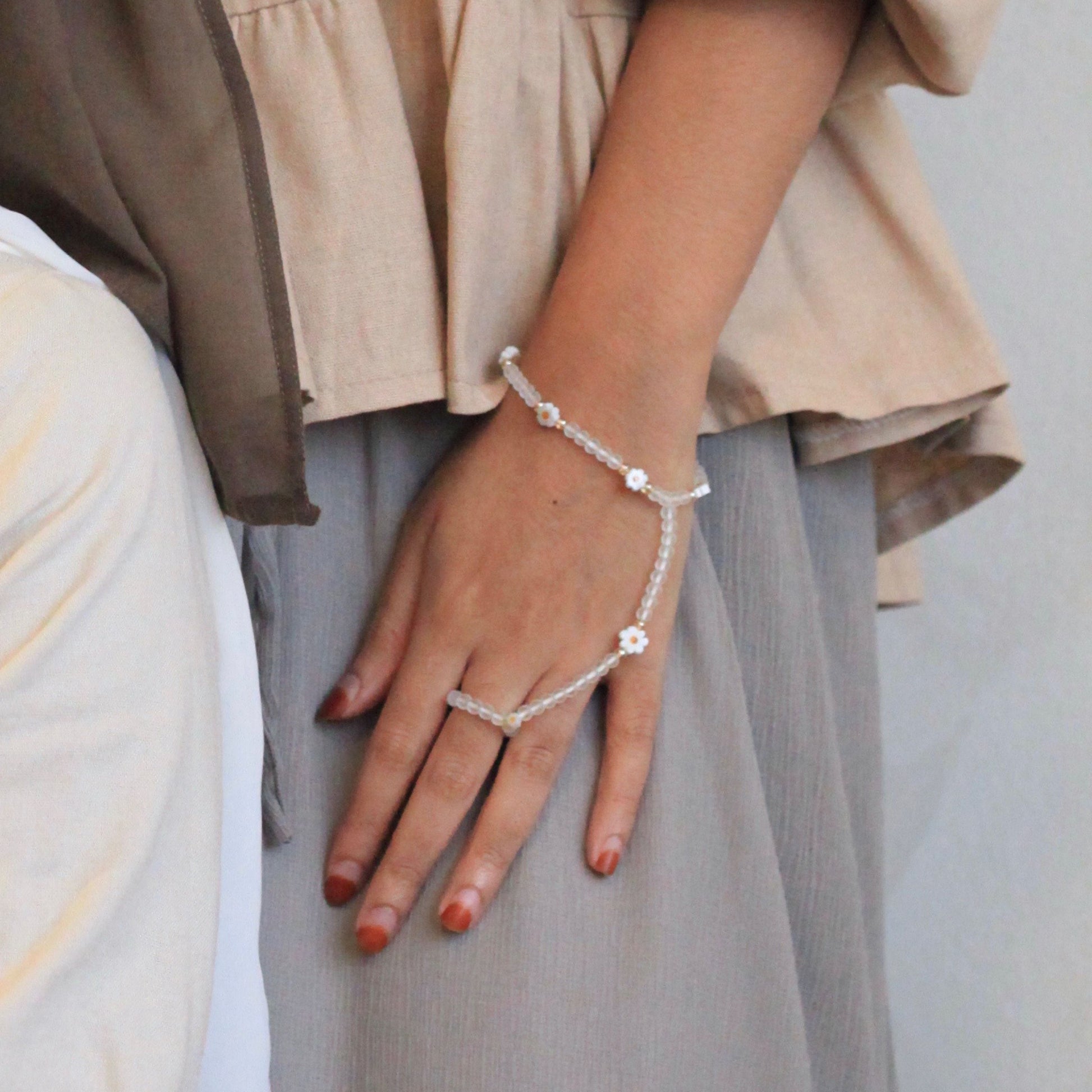 Daisy Dainties handchain by Dreamers’ Side featuring frosted beads and daisy accents, an elegant feminine jewellery piece linking wrist and finger