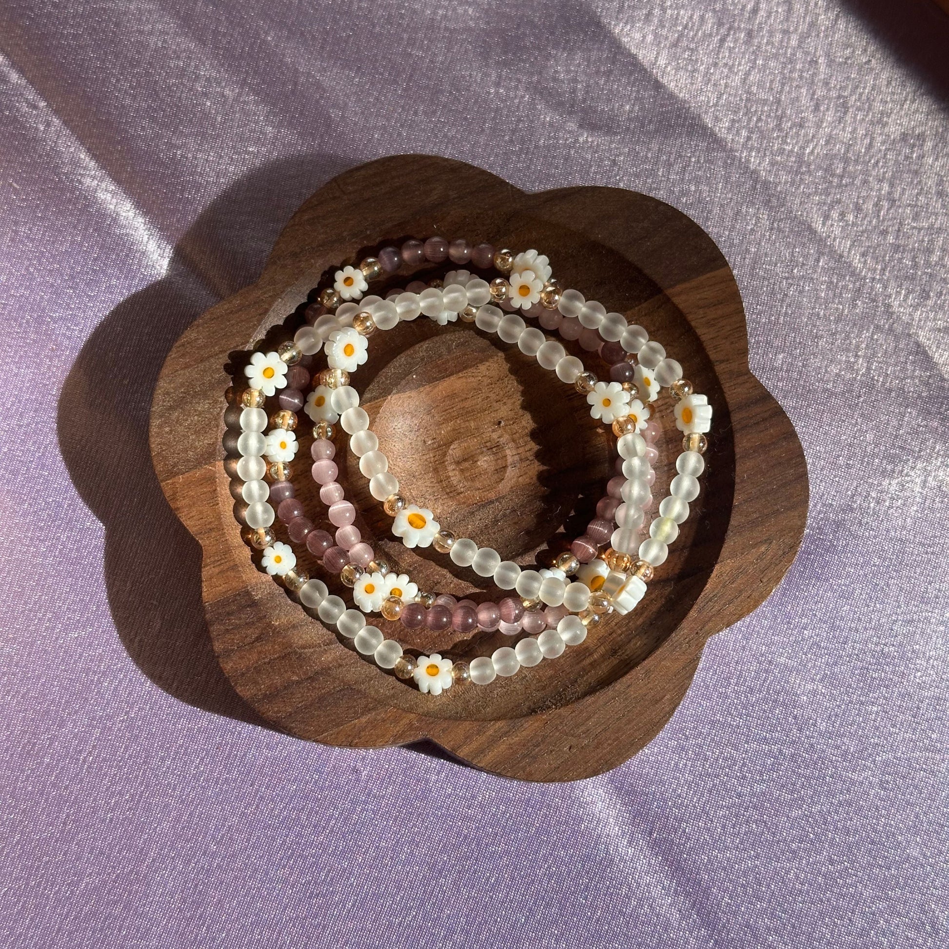 Close-up of Daisy Dainties jewellery showing frosted agate beads, soft pastel tones, and tiny daisy accents for delicate styling