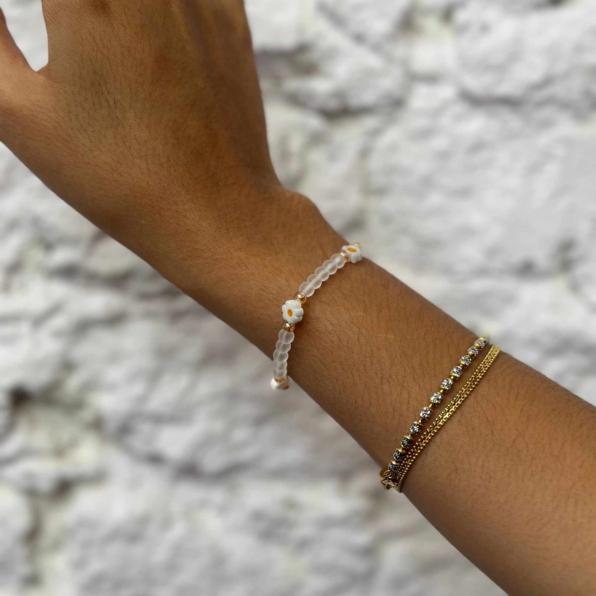 Woman wearing Daisy Dainties bracelet, a soft pastel modest accessory styled for elegant everyday and layered jewellery looks