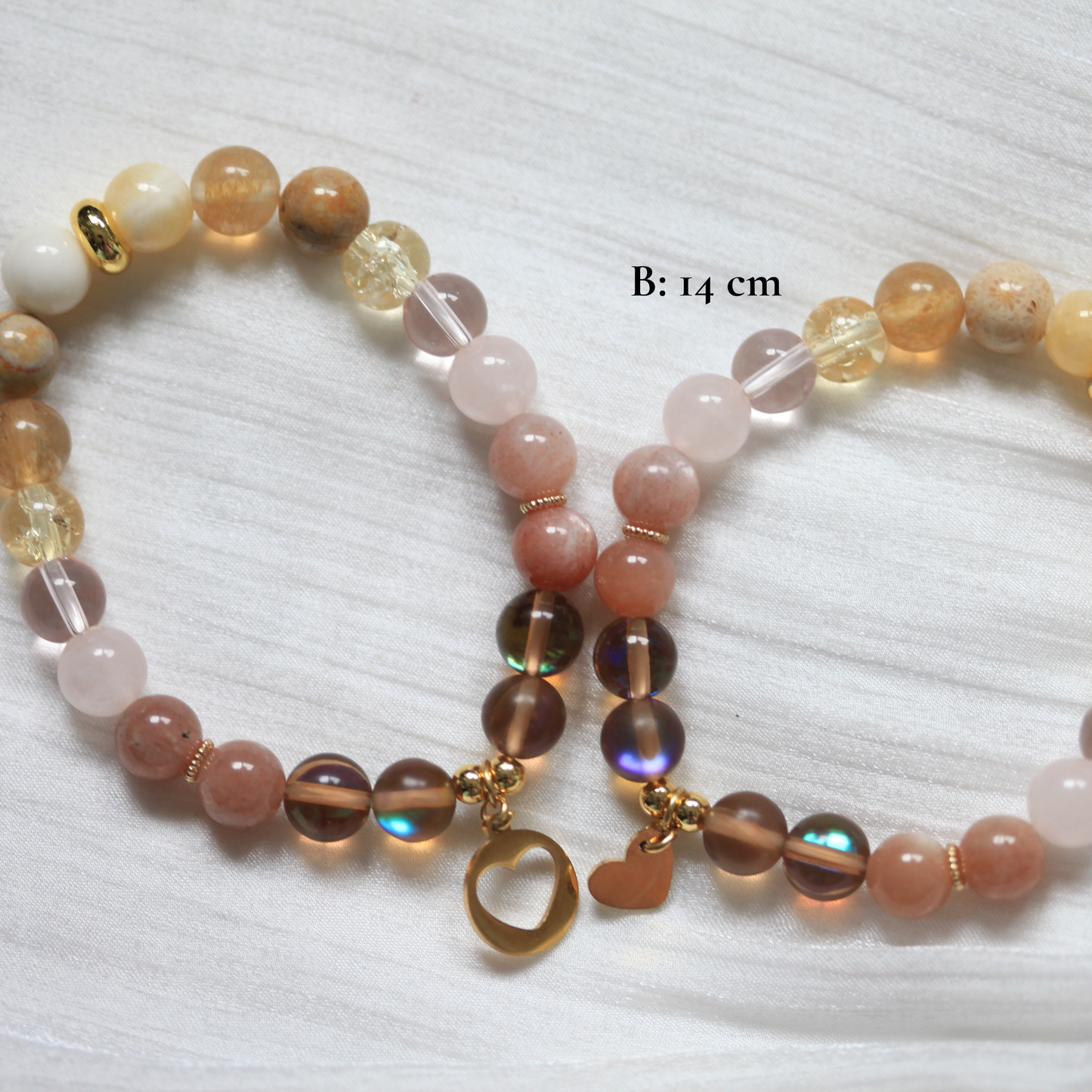 Beaded matching bracelet with multicolored beads and a gold charm on a white background