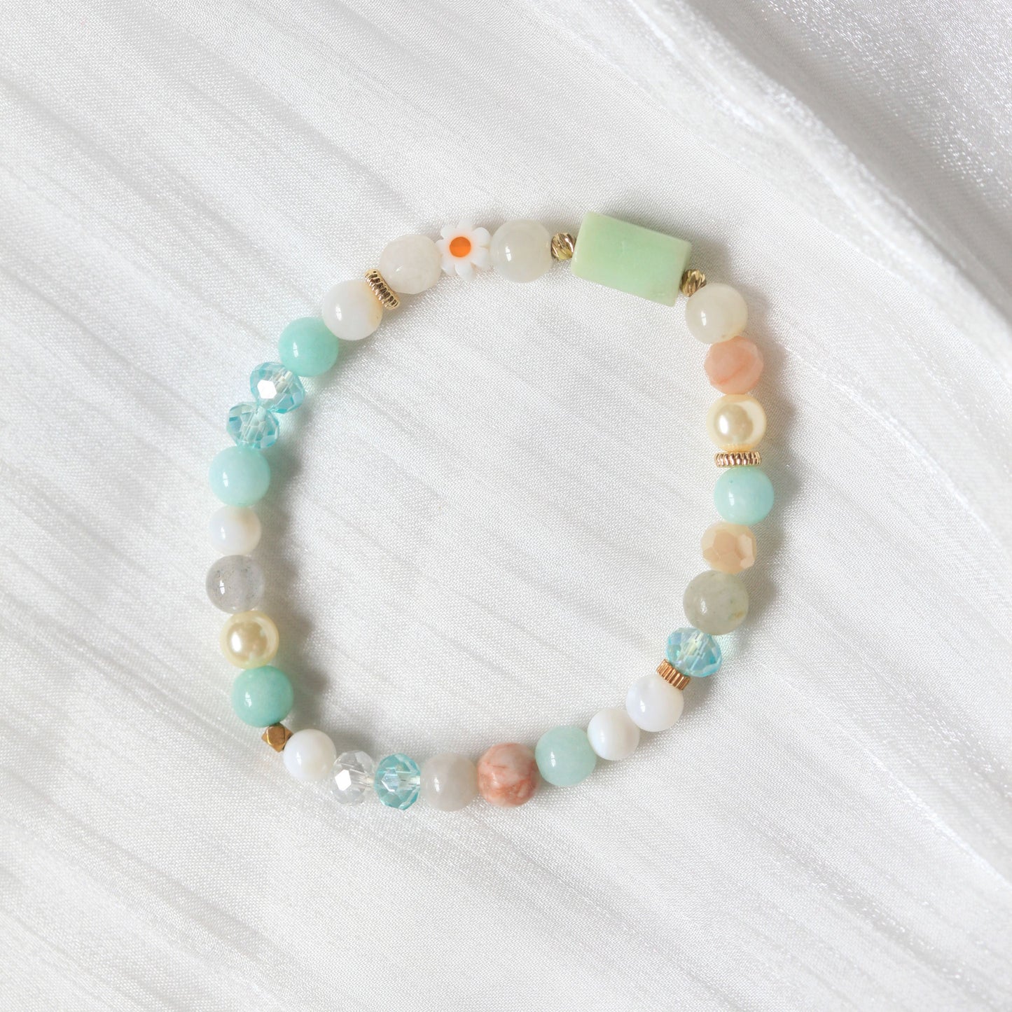 Dreamtide bracelet in Mist pink, Aura blue, and Eclipse Dew teal pastel shades with natural stones and delicate bead details