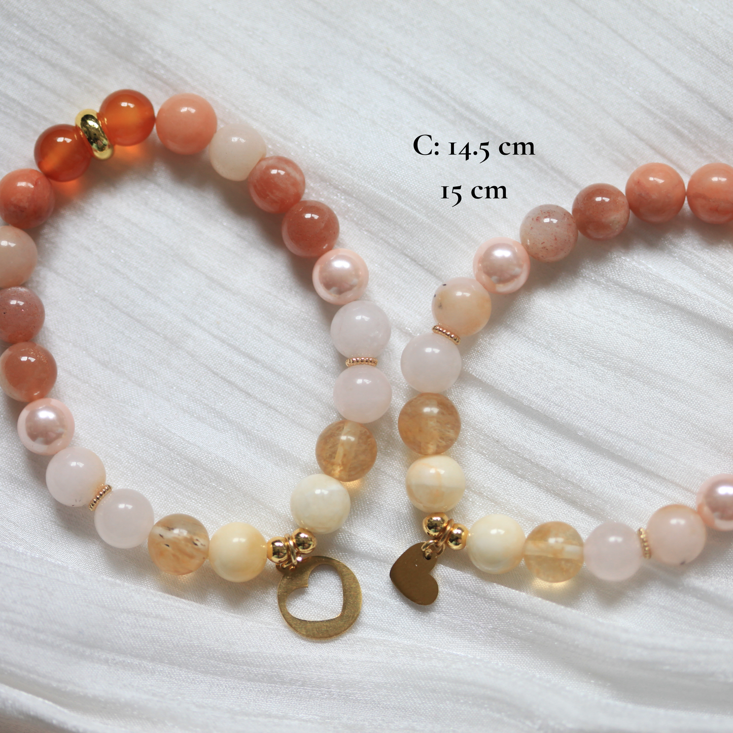 Two beaded bracelets on a white textured surface with measurements indicated.