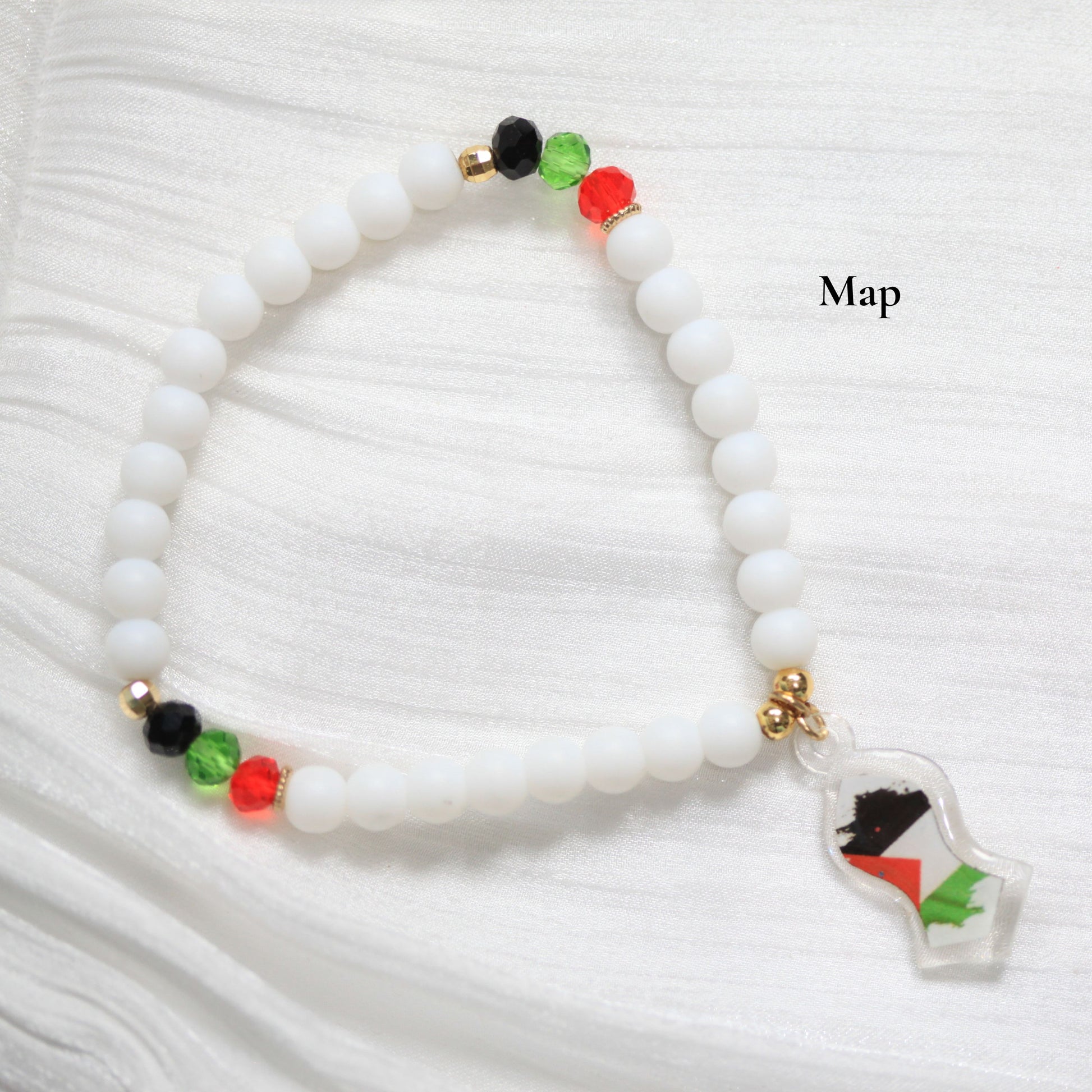 White beaded bracelet with a map charm on a white background