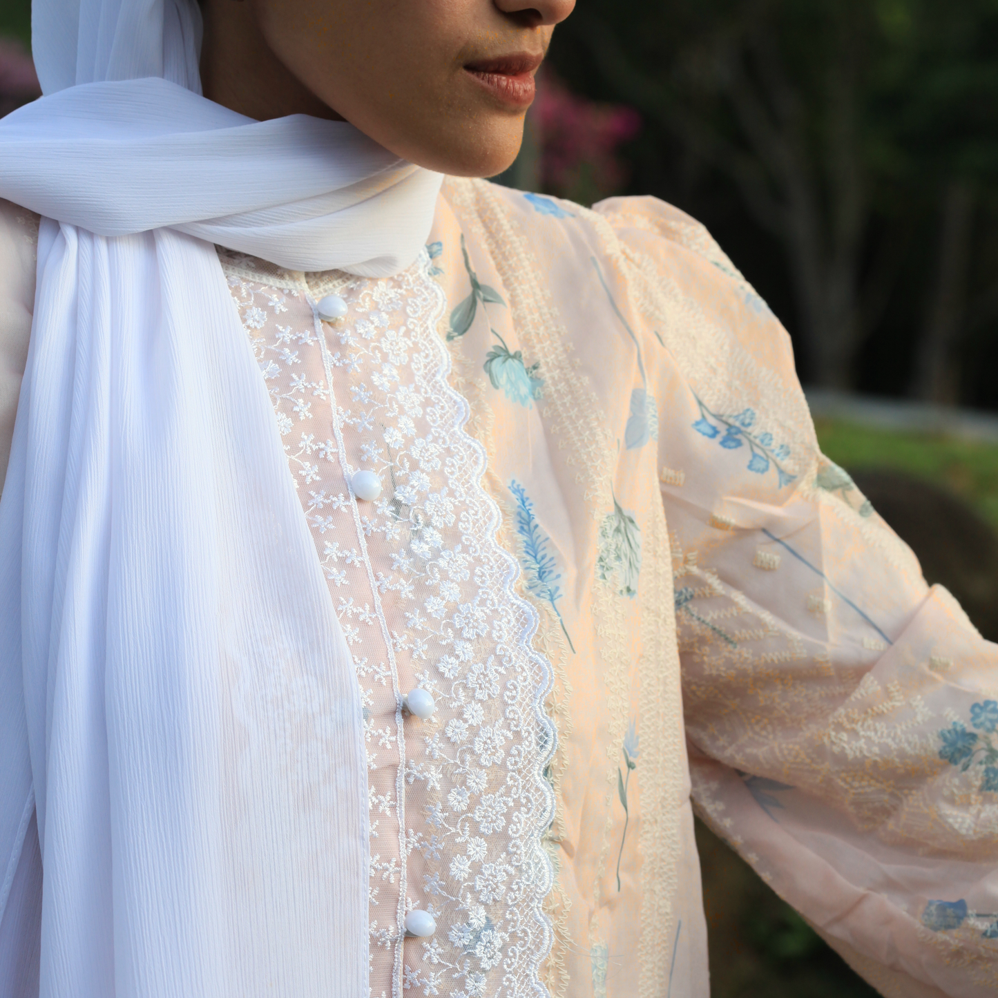 Close-up of Rosemary Verse blouse showing soft floral textured fabric and delicate lace detailing representing growth, femininity, and modest elegance